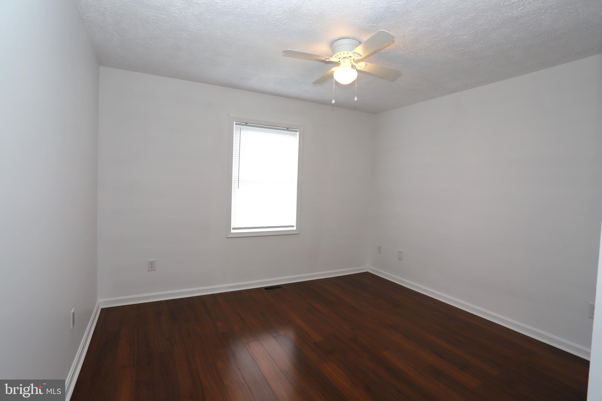 14459 Norman Road Culpeper, VA 22701 - Photo 12 of 23 an empty room with wooden floor and windows