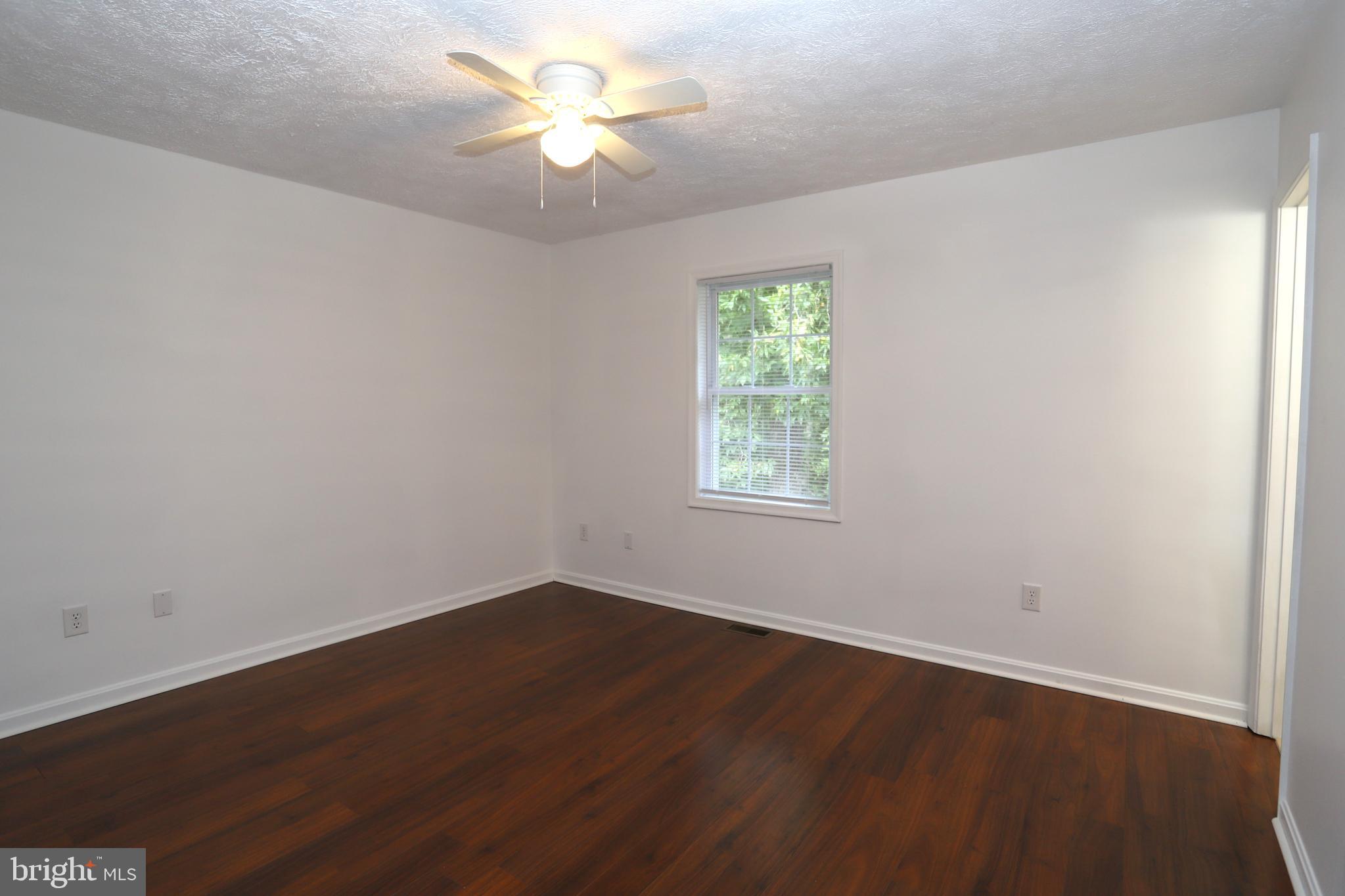 14459 Norman Road Culpeper, VA 22701 - Photo 13 of 23 an empty room with wooden floor and window