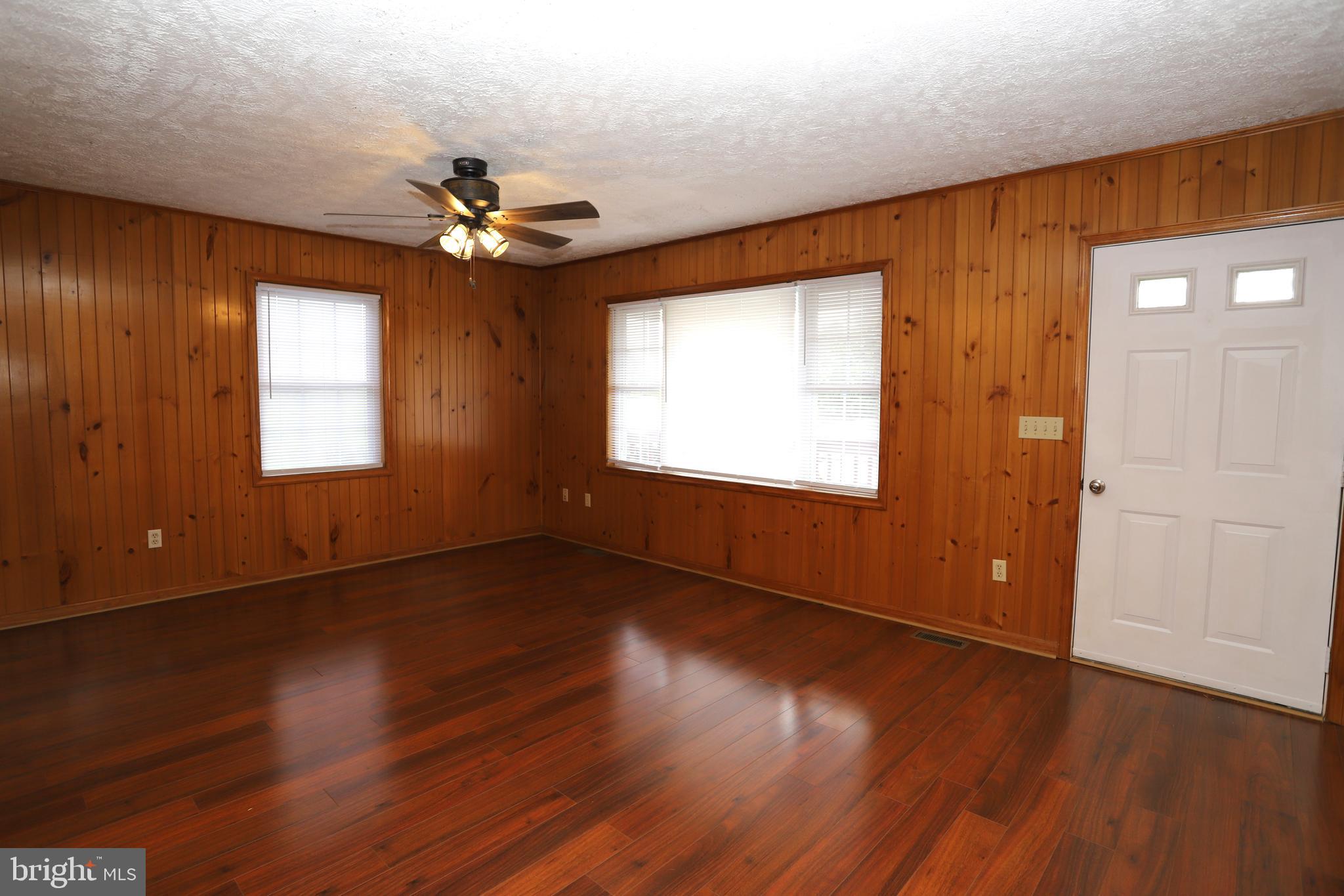 14459 Norman Road Culpeper, VA 22701 - Photo 6 of 23 a view of an empty room with wooden floor and a window