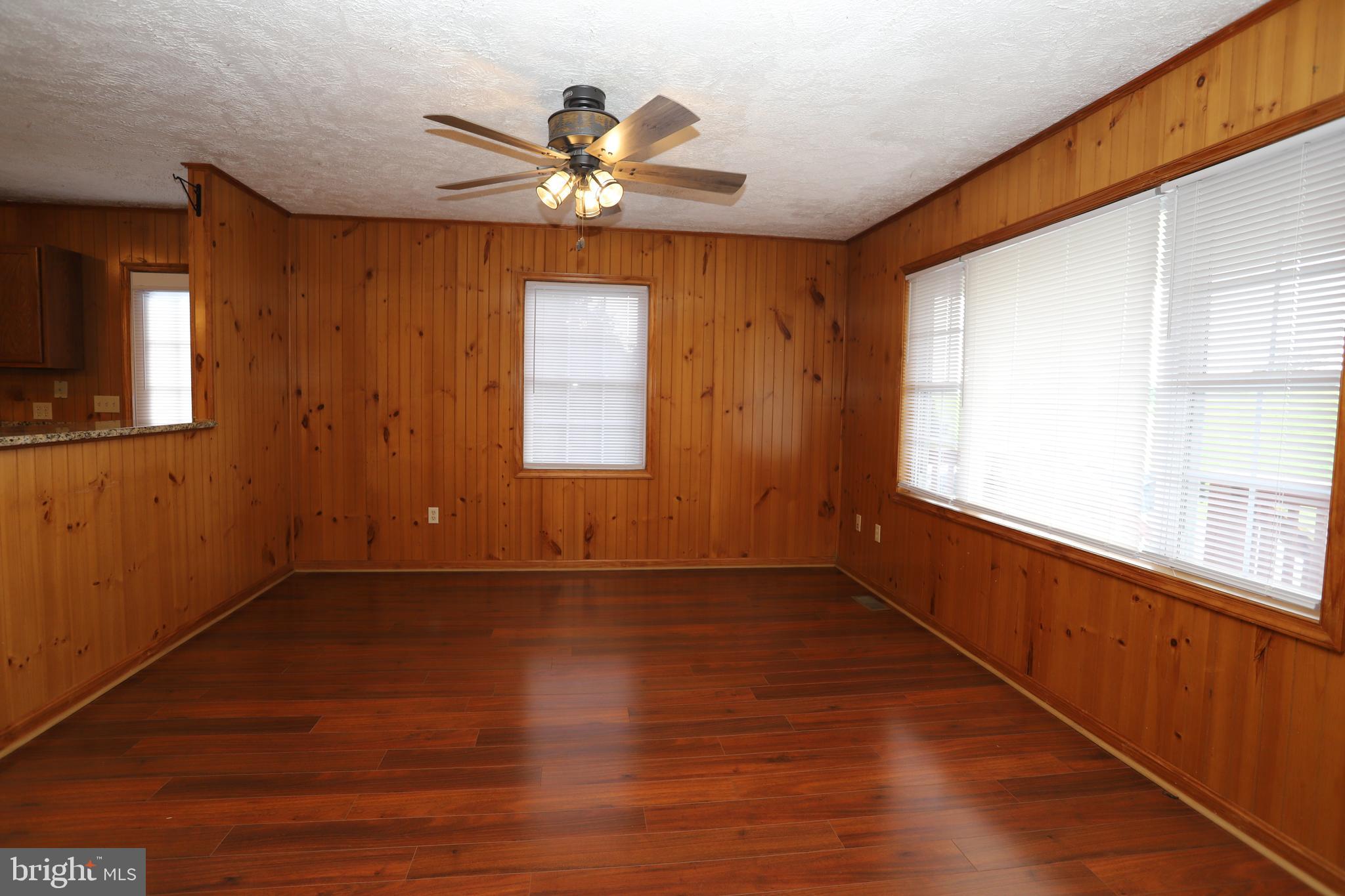 14459 Norman Road Culpeper, VA 22701 - Photo 7 of 23 a view of an empty room with a window and wooden floor