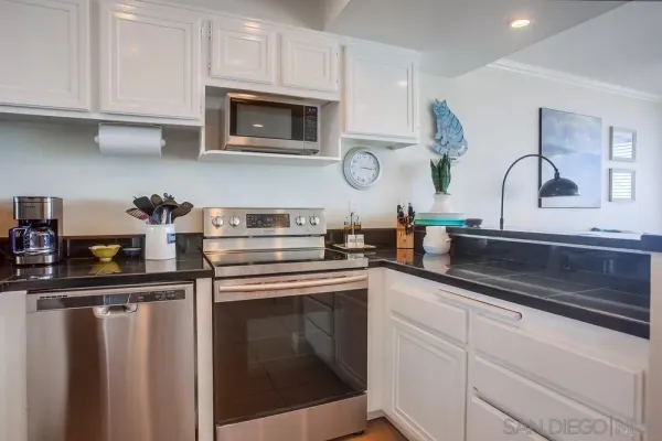 a kitchen with stainless steel appliances granite countertop a sink and cabinets