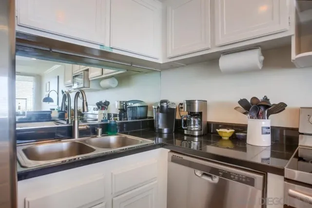 a kitchen with a sink and cabinets