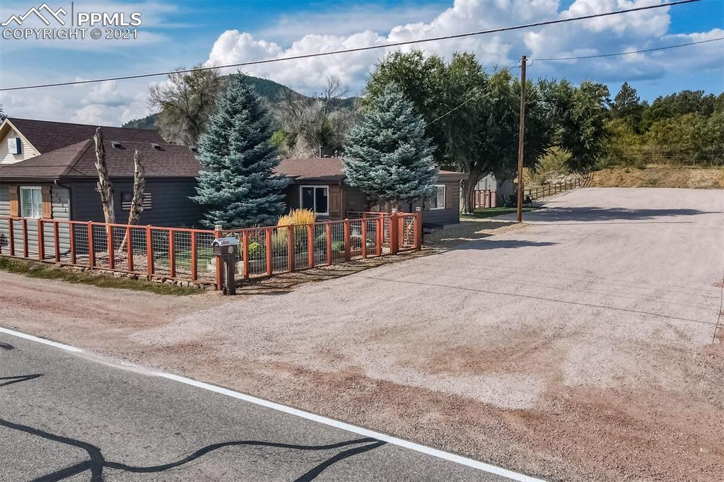 8977 Spruce Mountain Road Larkspur, CO 80118 - Photo 2 of 50 a view of a house with a street