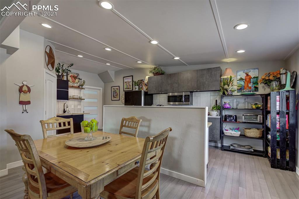 8977 Spruce Mountain Road Larkspur, CO 80118 - Photo 12 of 50 a view of a dining room with furniture and wooden floor