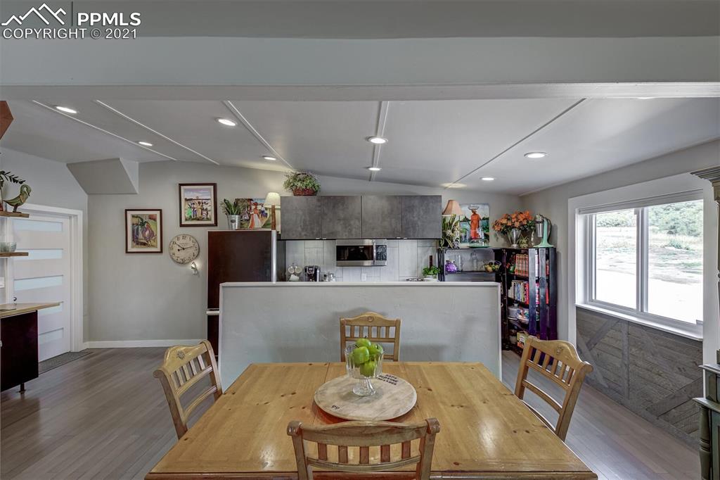 8977 Spruce Mountain Road Larkspur, CO 80118 - Photo 13 of 50 a living room with stainless steel appliances furniture a dining table and kitchen view