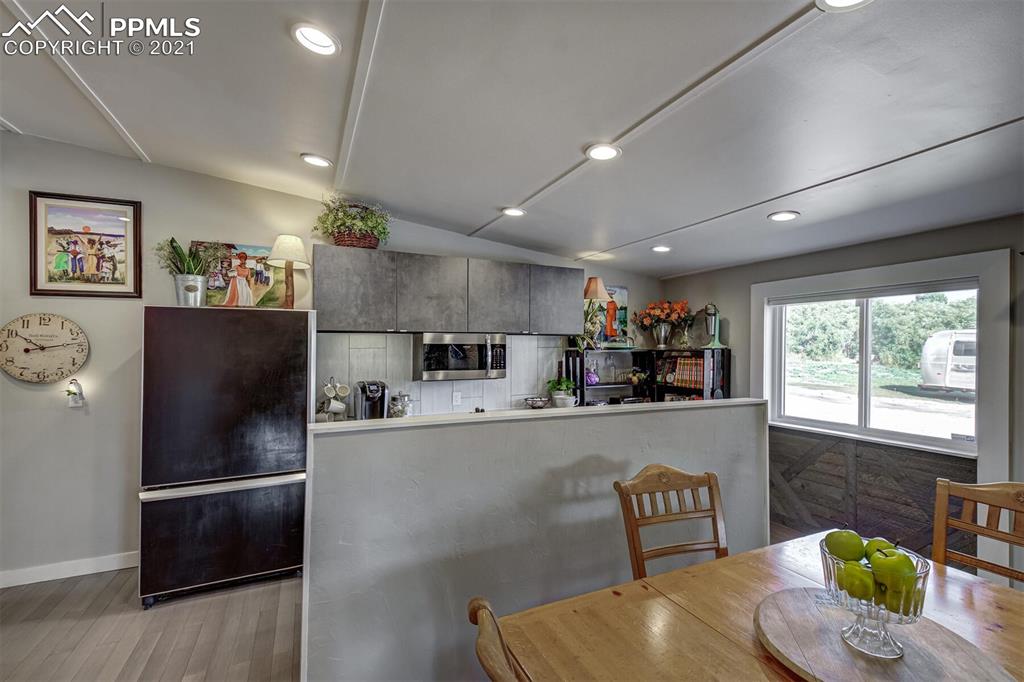 8977 Spruce Mountain Road Larkspur, CO 80118 - Photo 14 of 50 a kitchen with stainless steel appliances granite countertop a refrigerator and a dining table