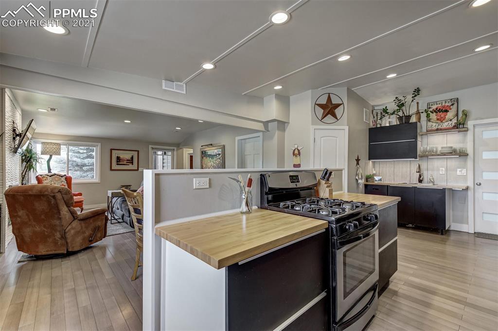 8977 Spruce Mountain Road Larkspur, CO 80118 - Photo 17 of 50 a kitchen with stainless steel appliances granite countertop a stove and a refrigerator