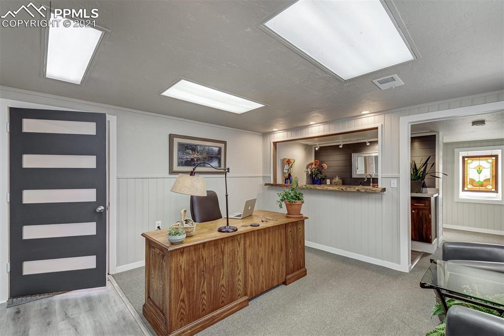 8977 Spruce Mountain Road Larkspur, CO 80118 - Photo 23 of 50 a living room with furniture and a flat screen tv