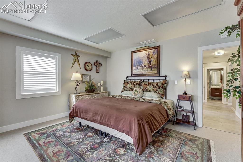 8977 Spruce Mountain Road Larkspur, CO 80118 - Photo 32 of 50 a bedroom with a bed and a window