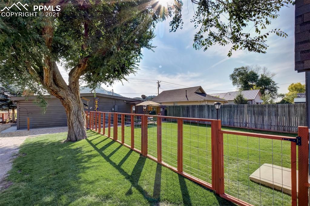 8977 Spruce Mountain Road Larkspur, CO 80118 - Photo 36 of 50 a view of a house with backyard and a tree