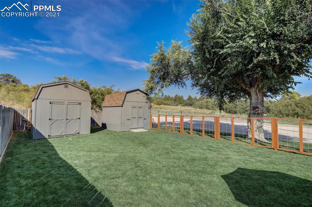 8977 Spruce Mountain Road Larkspur, CO 80118 - Photo 38 of 50 a view of a house with a yard