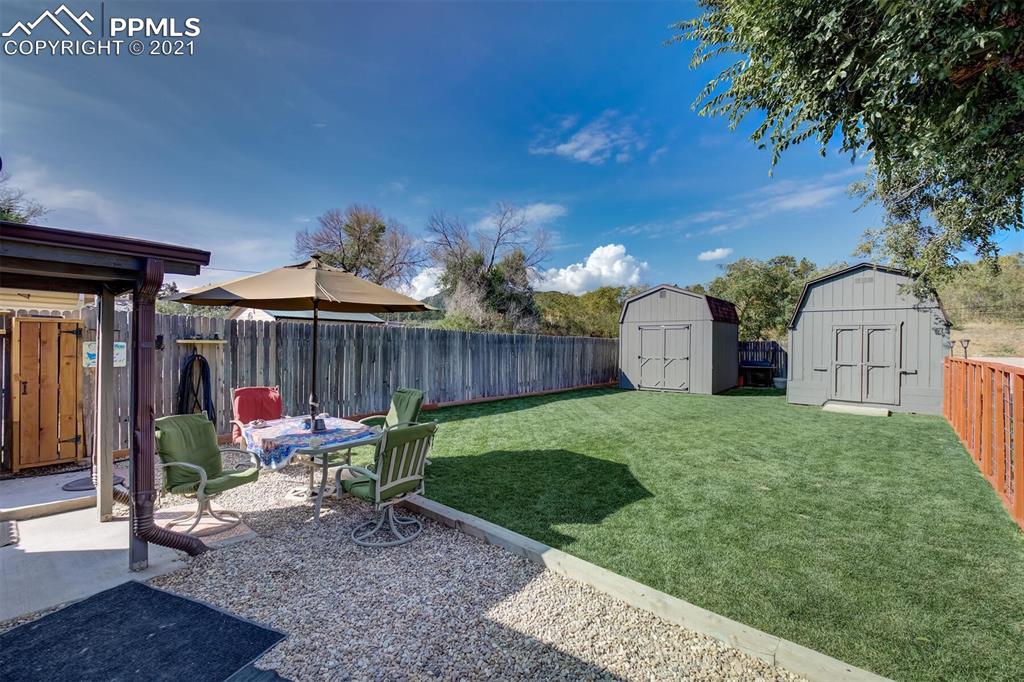 8977 Spruce Mountain Road Larkspur, CO 80118 - Photo 39 of 50 a view of a chair and table in backyard of the house