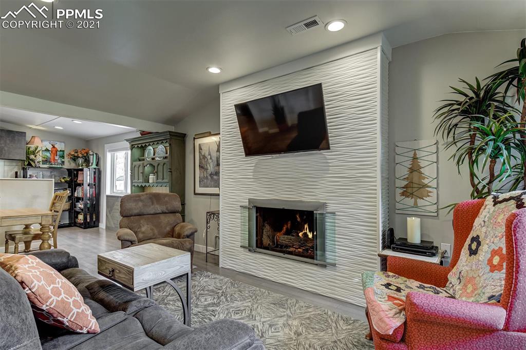 8977 Spruce Mountain Road Larkspur, CO 80118 - Photo 7 of 50 a living room with furniture or flat screen tv and a fireplace