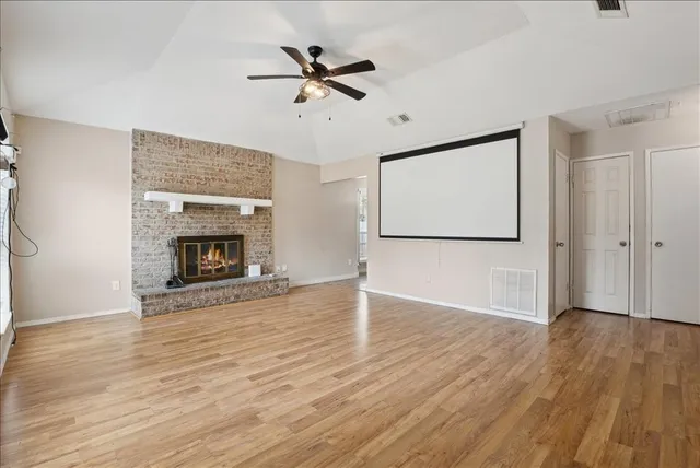 wooden floor fireplace and natural light in room
