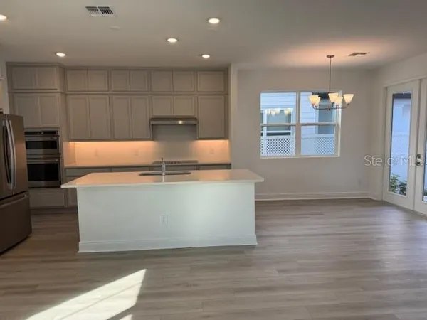 a view of kitchen with wooden floor and window