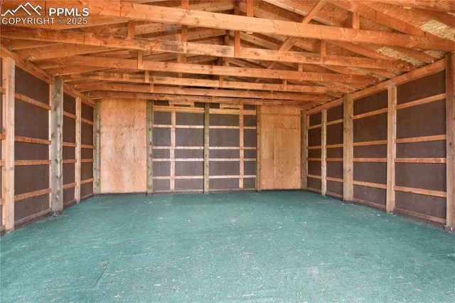 a view of an empty room with a wooden fence