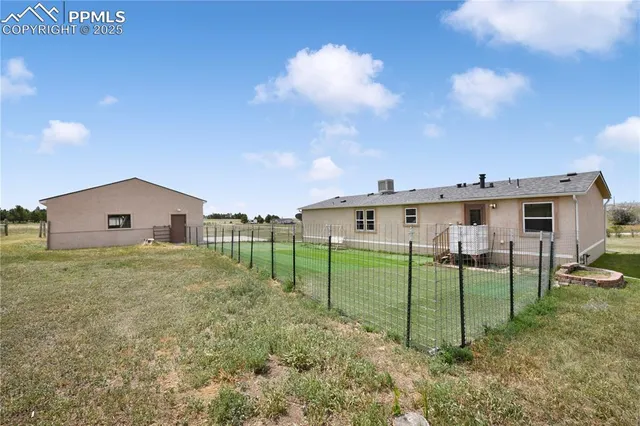a view of a house with a backyard and a yard