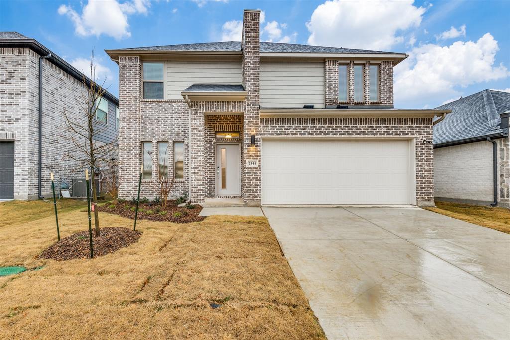 View of front of house featuring a garage and a front yard