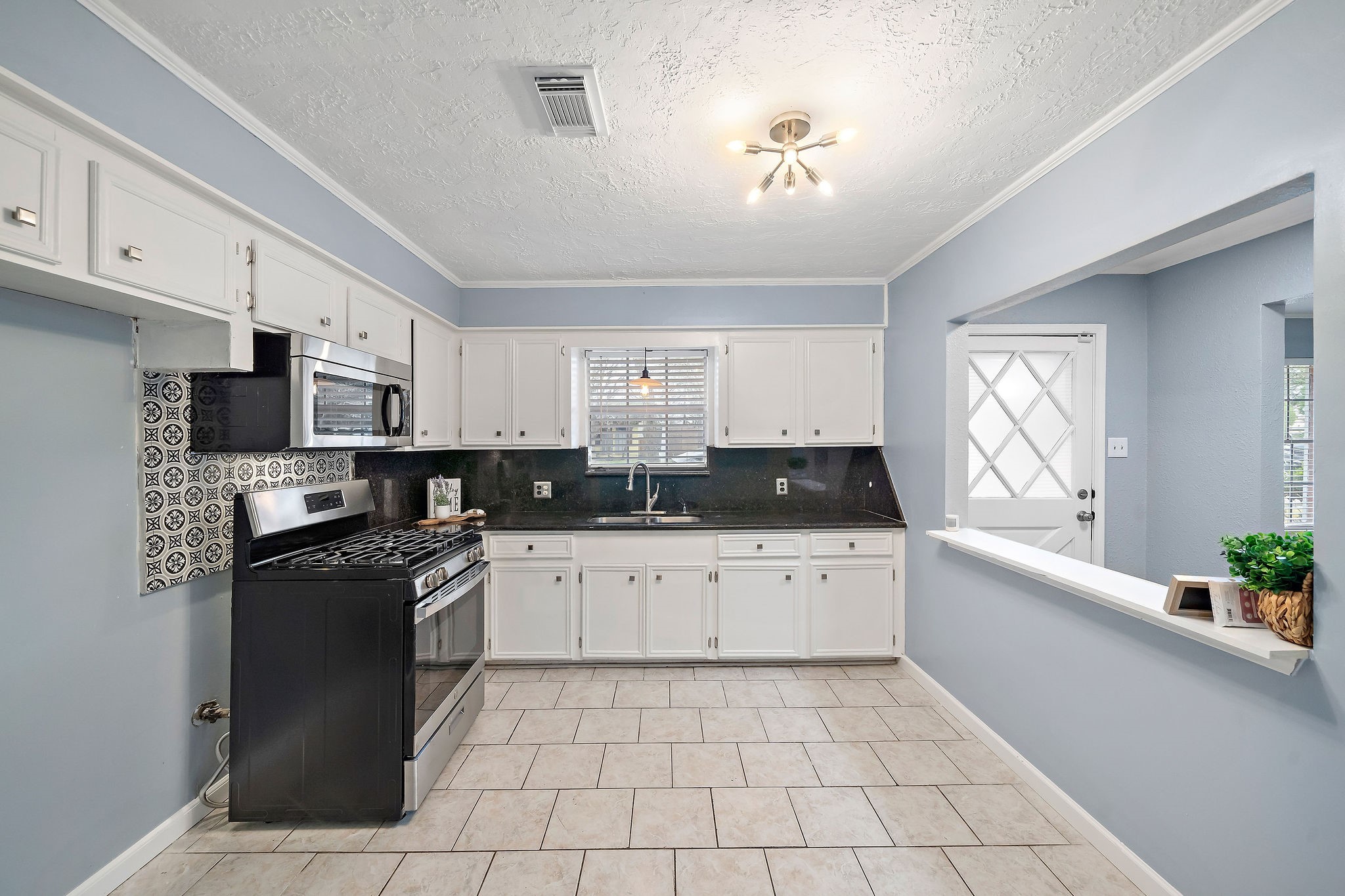 712 Damon Street Rosenberg, TX 77471 - Photo 4 of 11 a large kitchen with stainless steel appliances granite countertop a stove a sink dishwasher and a refrigerator