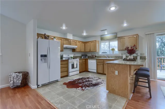 a kitchen with a white cabinets and white appliances