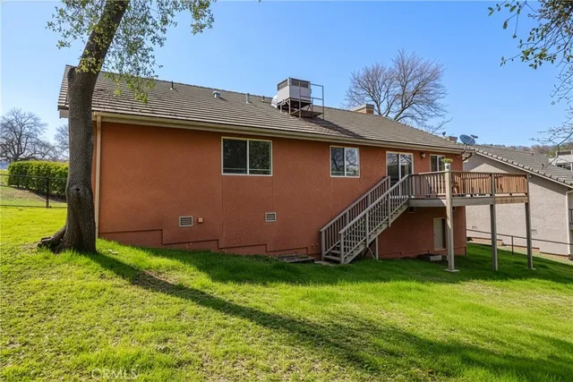 a view of a house with wooden deck