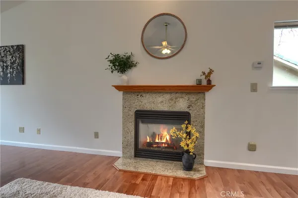 a living room with fireplace furniture and a wooden floor