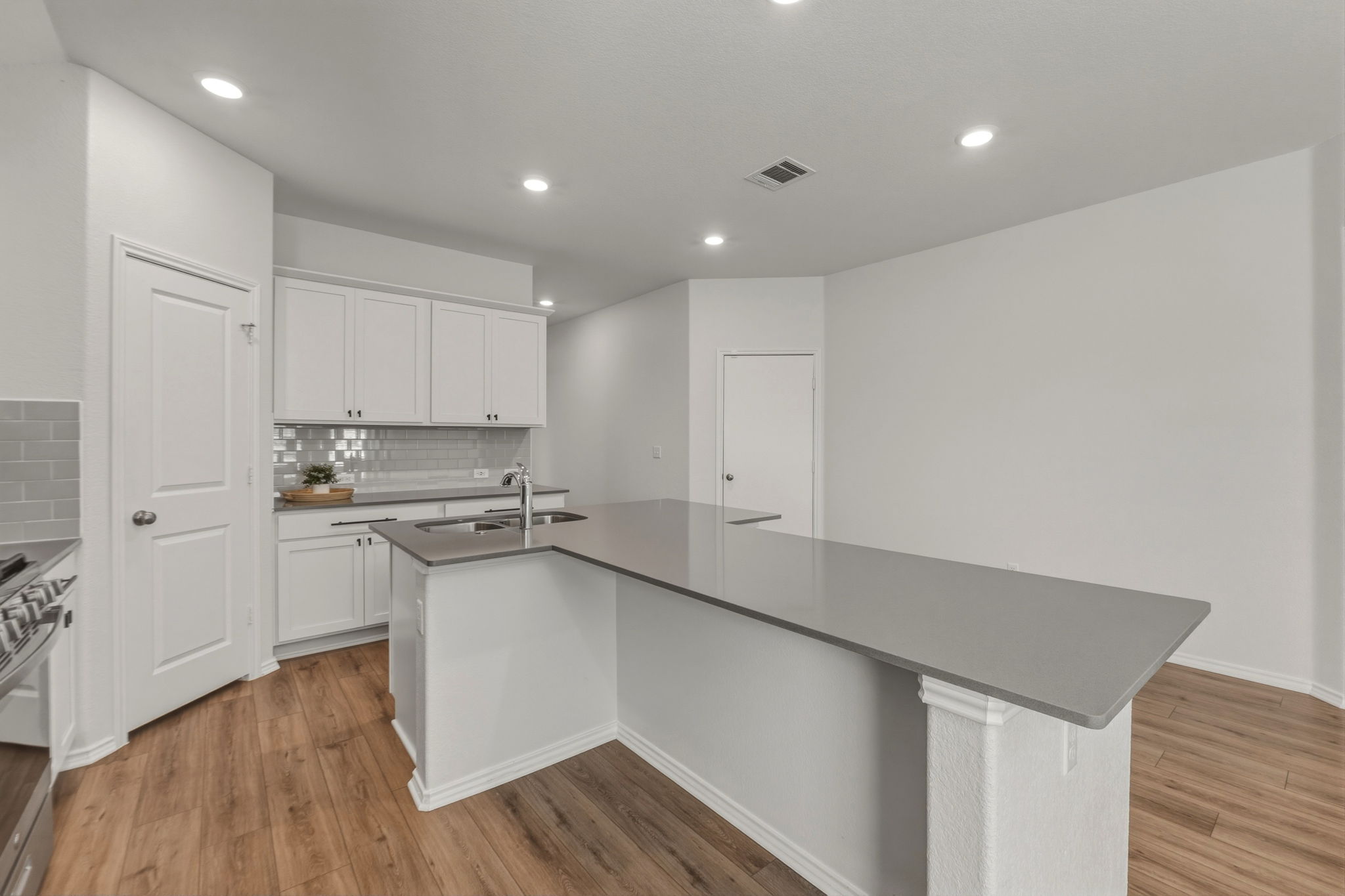405 Doherty Kyle, TX 78640 - Photo 11 of 40 The shape of this island is functional for work space or enjoying conversation in the kitchen
