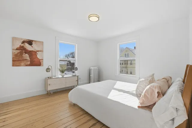 a bedroom with a large bed and a window