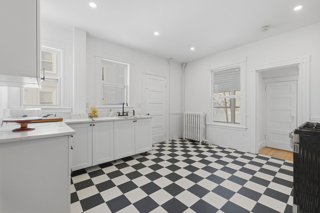 30 Massasoit Street Boston, MA 02136 - Photo 3 of 22 a kitchen with a checkered floor and white cabinets