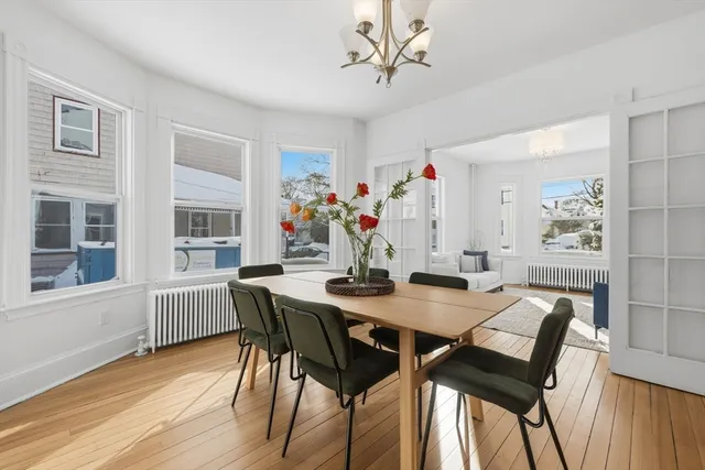 a view of a dining room with furniture and wooden floor