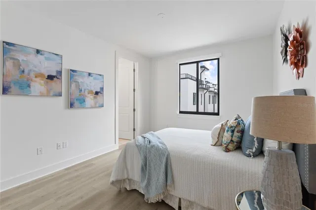 a bedroom with a bed and a lamp