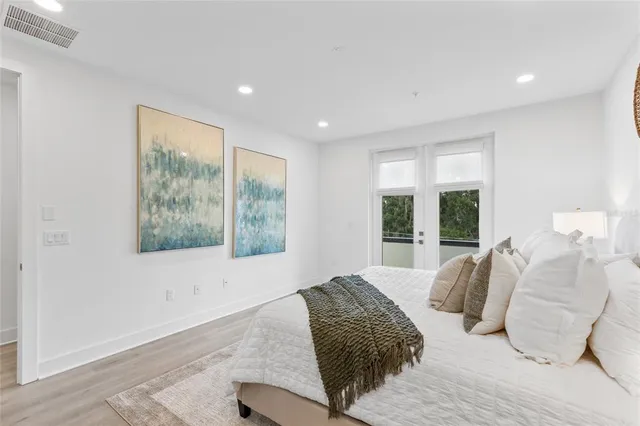 a bedroom with a bed and a large window