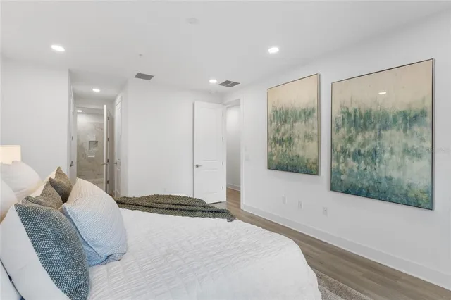 a bedroom with a large bed and a large window