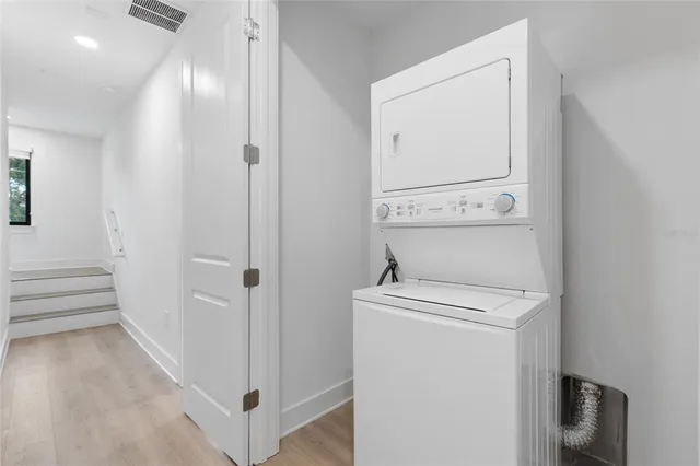 a view of a hallway with washer and dryer