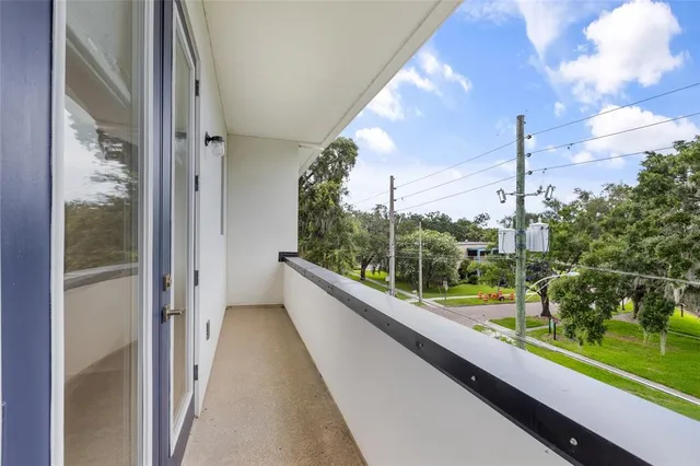 a view of a balcony with yard