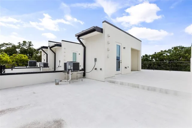 a view of a house with roof and sitting area
