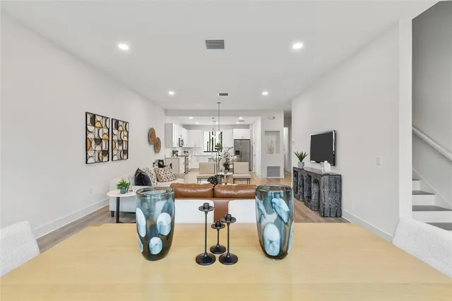 a dining room with lots of furniture and wooden floor
