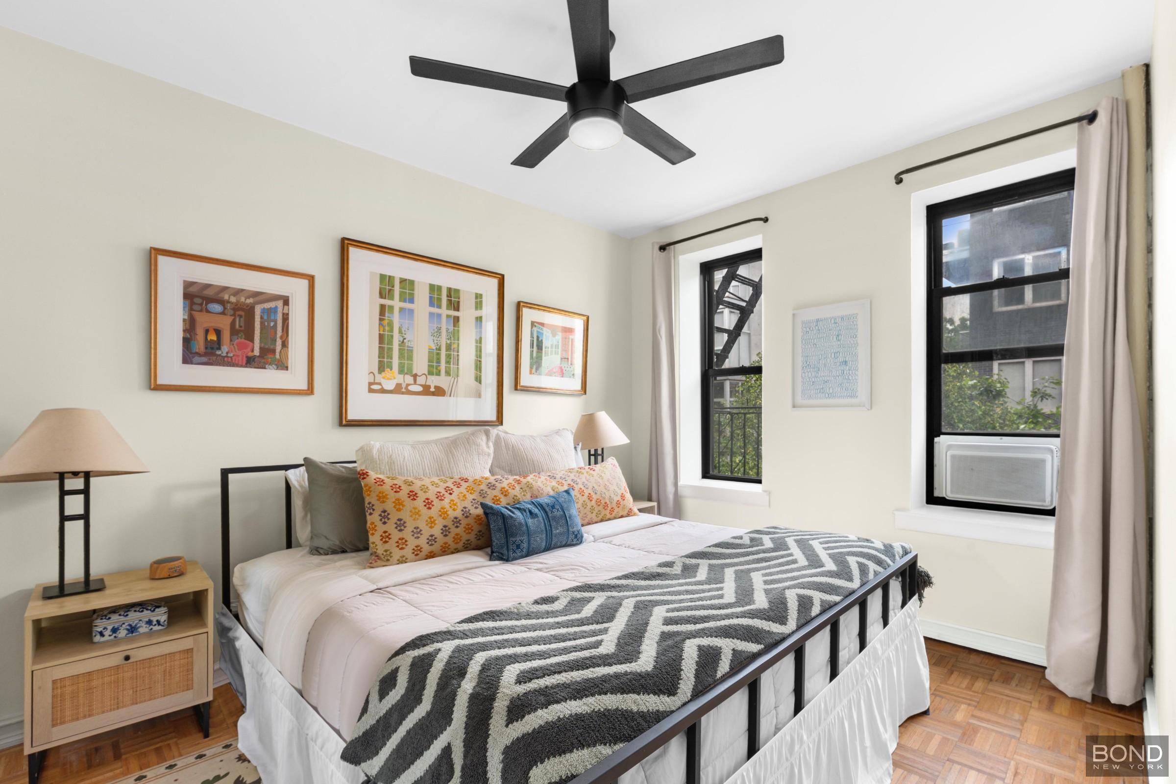 124 South 3rd Street, Unit 8 Brooklyn, NY 11249 - Photo 3 of 6 a bedroom with a bed and a painting on the wall