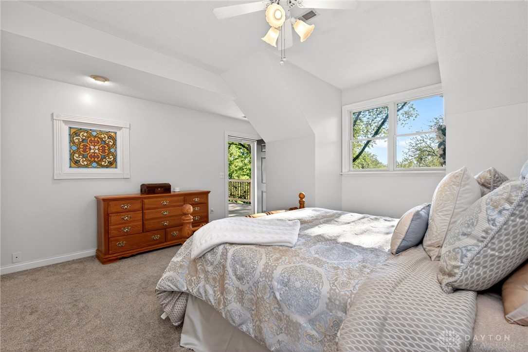 330 South Alpha Bellbrook Road Bellbrook, OH 45305 - Photo 36 of 87 This airy bedroom offers a comfortable retreat with plush carpet and direct balcony access.