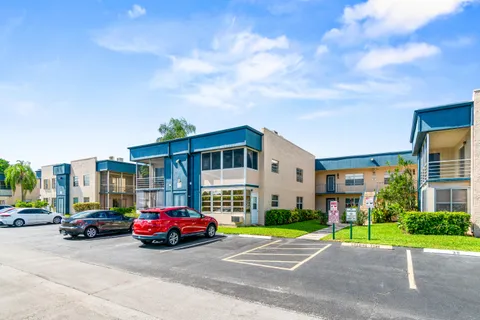 a car parked in front of a house and a yard