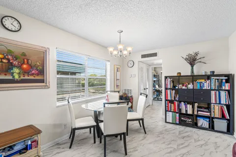 a dining room with furniture a book and a book shelf