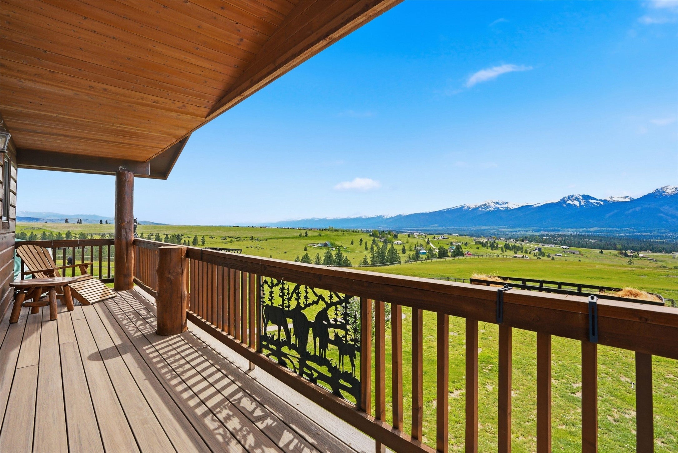679 Hidden Valley Road North Florence, MT 59833 - Photo 50 of 85 Expansive outdoor deck with composite decking and a wood railing featuring decorative metal inserts