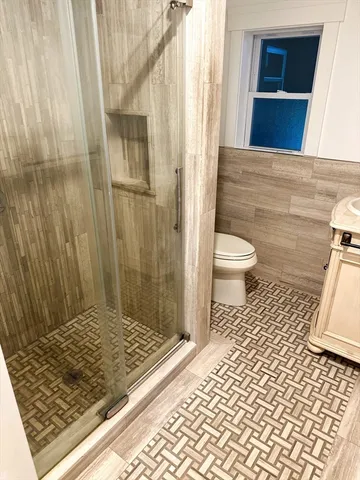 a bathroom with a toilet and a shower