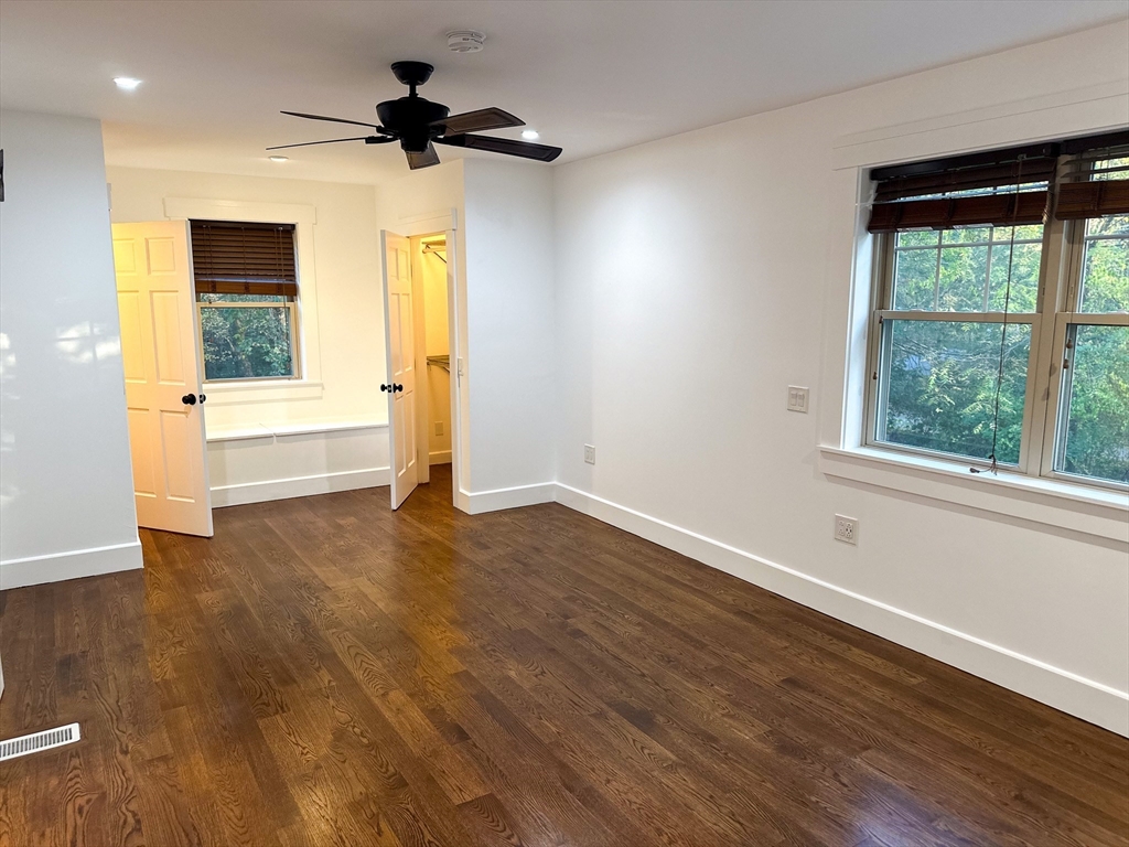 125 Maple Street Carlisle, MA 01741 - Photo 17 of 35 a view of an empty room with a window and wooden floor