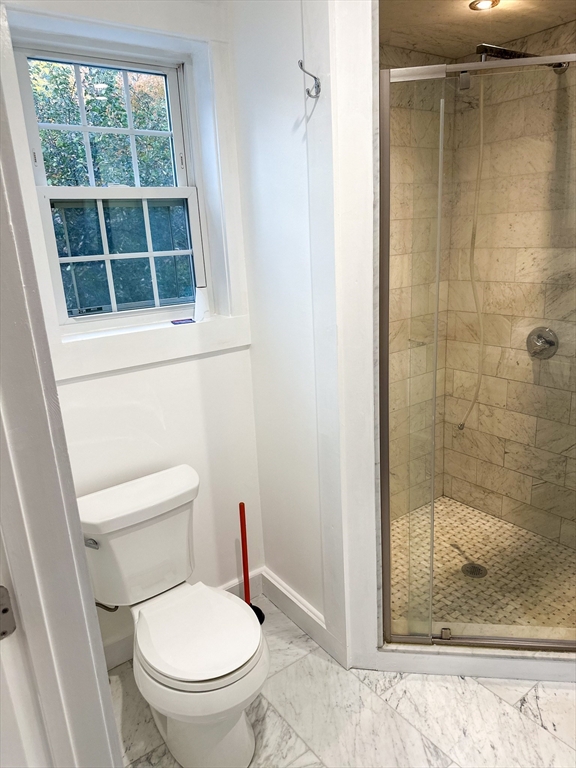 125 Maple Street Carlisle, MA 01741 - Photo 22 of 35 a white toilet sitting next to a shower