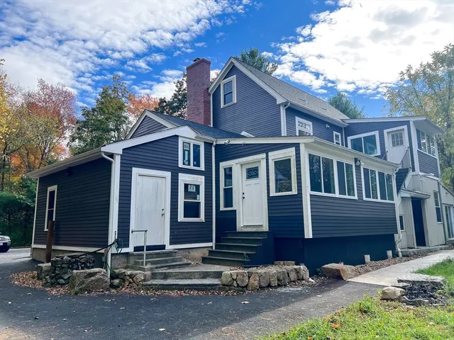 a view of a house with a yard