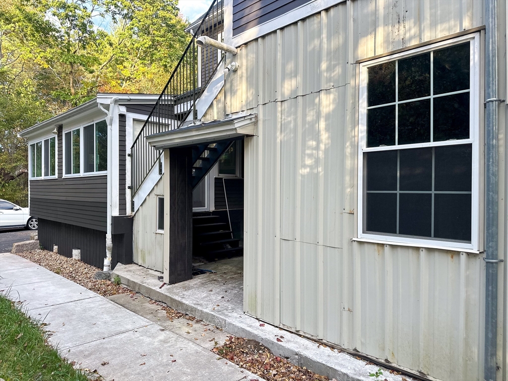125 Maple Street Carlisle, MA 01741 - Photo 26 of 35 a view of a house with a large window and wooden walls