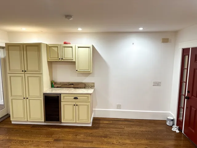 a kitchen with stainless steel appliances granite countertop a refrigerator a stove and a sink