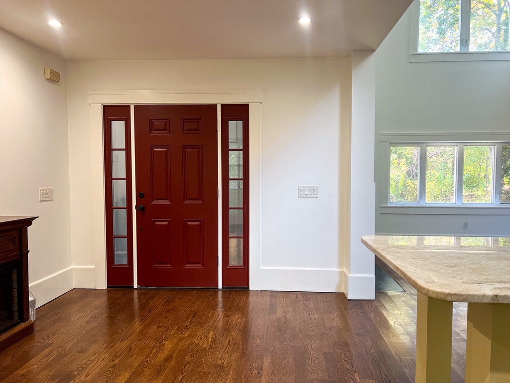 125 Maple Street Carlisle, MA 01741 - Photo 4 of 35 an empty room with wooden floor and windows