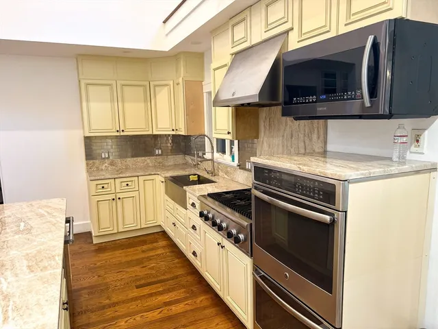 a kitchen with a stove microwave and sink